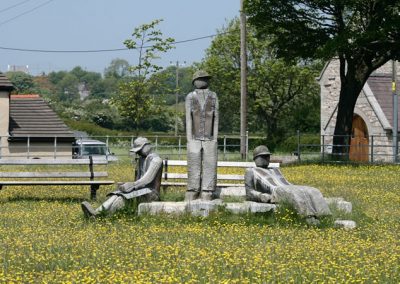 A sculpture depicting three resting miners